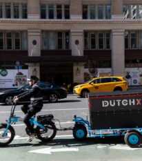 delivery man on e-bike with trailer